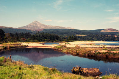 Scenic view of lake with goat fell mountain in background