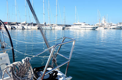 Sailboats moored in harbor