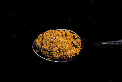 Close-up of bread against black background