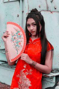 Portrait of young woman wearing red traditional clothing