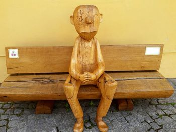 Close-up of statue against wooden wall