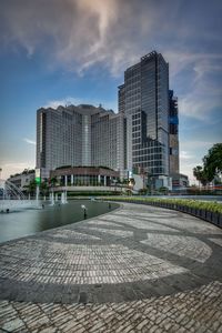 Modern building against cloudy sky