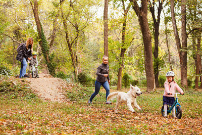 People with dog in forest
