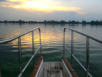 Scenic view from the boat of lake against sky during sunset