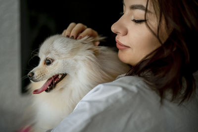 Young woman with pomeranian dog