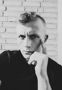 Portrait of young man against wall