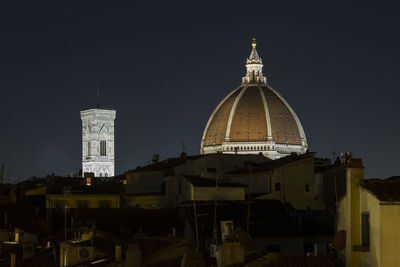 View of buildings in city against sky at night