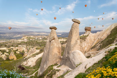 Scenic view of sea against sky, cappadocia. rock formations and hot air balloons