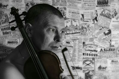 Close-up of man holding violin