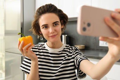 Portrait of young woman using mobile phone