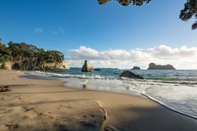 Scenic view of sea against blue sky at cathedral cove