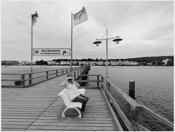 Rear view of man walking on pier