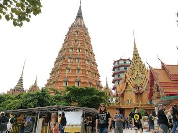 People at temple against sky