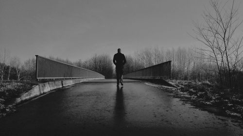 Full length of woman walking on road