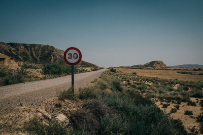 Road sign against clear sky