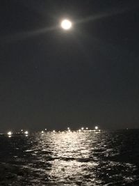 Scenic view of sea against clear sky at night