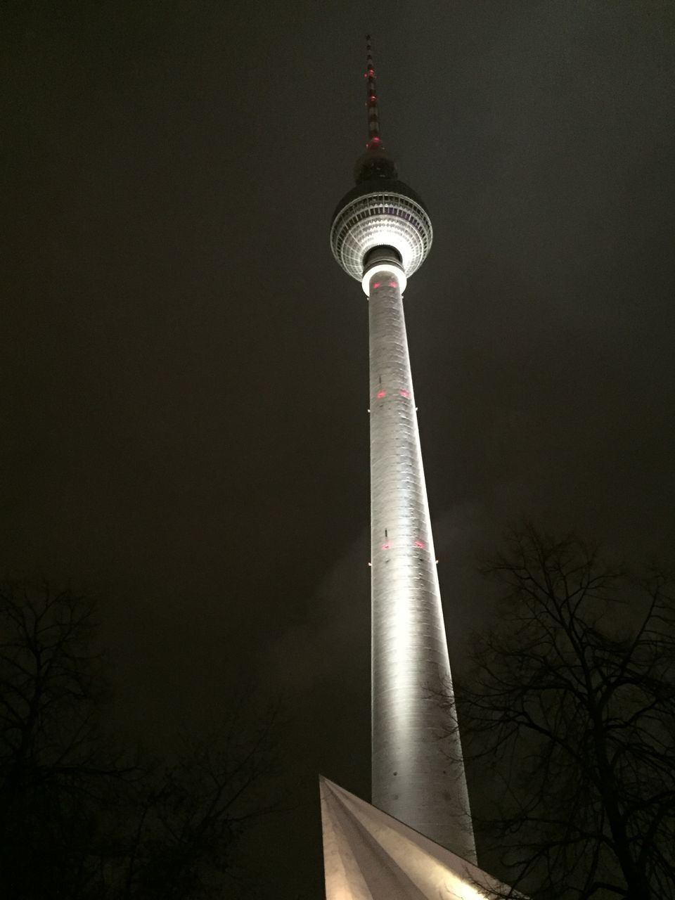 low angle view, architecture, built structure, tower, building exterior, tall - high, famous place, communications tower, travel destinations, travel, night, international landmark, spire, sky, tourism, illuminated, capital cities, tree, religion