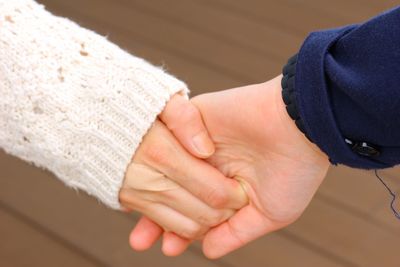 Close-up of couple holding hands