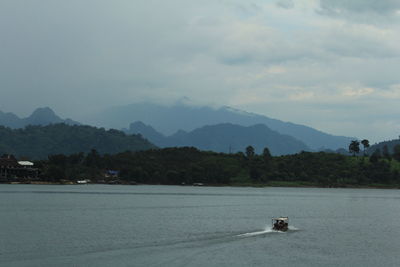 Scenic view of sea and mountains against sky