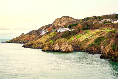 Scenic view of sea and mountains against sky