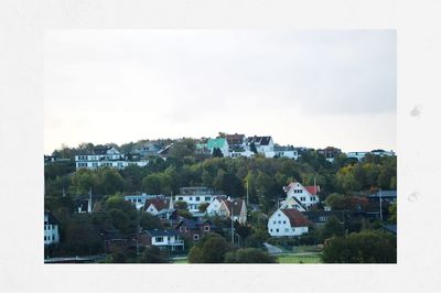 Houses in town against sky