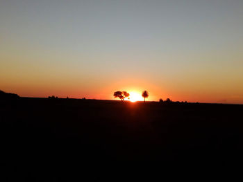 Scenic view of silhouette landscape against clear sky during sunset