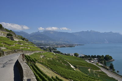 Scenic view of sea and mountains against sky