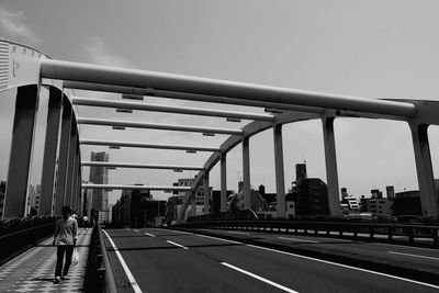 Bridge in city against clear sky