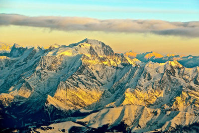 Scenic view of snowcapped mountains against sky during sunset