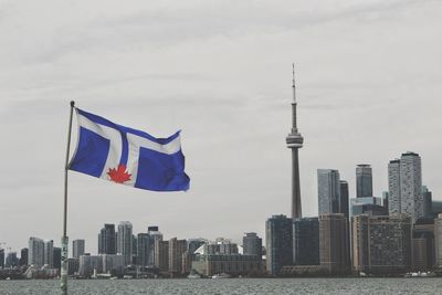 Flag against modern buildings in city