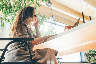 Creative woman working online at a co-working space.