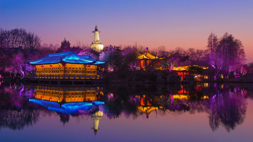 Scenic view of lake against sky at night