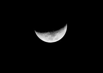 Low angle view of half moon against sky at night