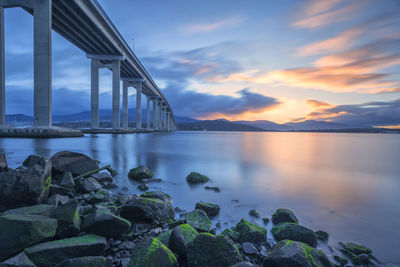 Scenic view of bridge over river against sky during sunset