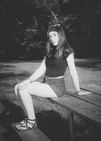 Portrait of young woman sitting outdoors