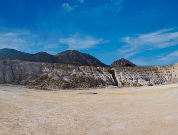 Scenic view of arid landscape against sky