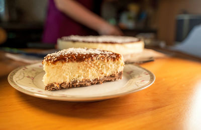 Pieces of a bounty chocolate cocoa creamy cake with coconut and grated biscuit as base being served