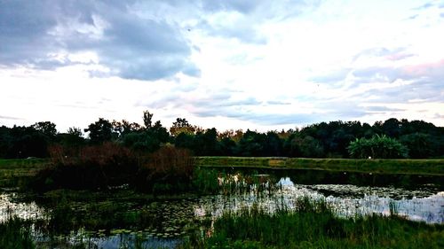 Scenic view of lake against cloudy sky