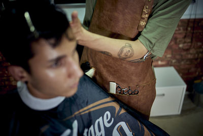 Midsection of man holding text while standing at home