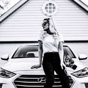 Full length of woman sitting in car