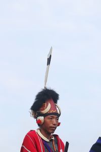 Rear view of man standing against clear sky