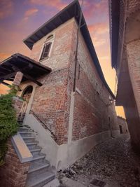 Low angle view of house against sky during sunset