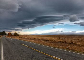Road by landscape against sky