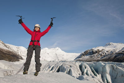 Woman feeling victorious on the fjallsjökull glacier in iceland