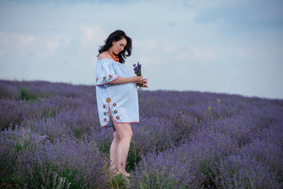 Full length of woman standing on field