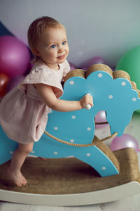 Portrait of cute girl playing with toys