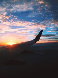 Cropped image of airplane flying over landscape