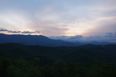 Scenic view of silhouette mountains against sky at sunset