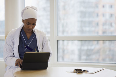 Young female doctor using tablet at work