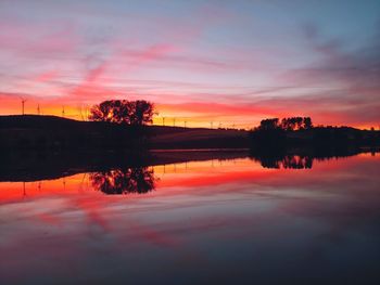 Scenic view of lake against romantic sky at sunset